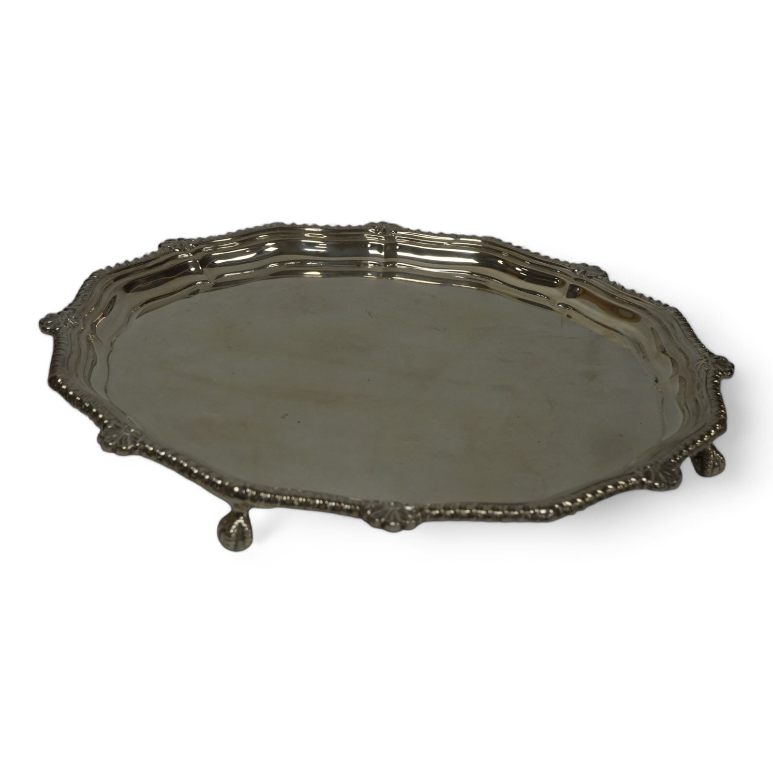 An Elizabeth II silver salver, of shaped circular form, with gadrooned border, on four claw and ball feet, Cooper Brothers & Sons, Sheffield, 1965, 26.8cm, 23.6oz. Condition - fair